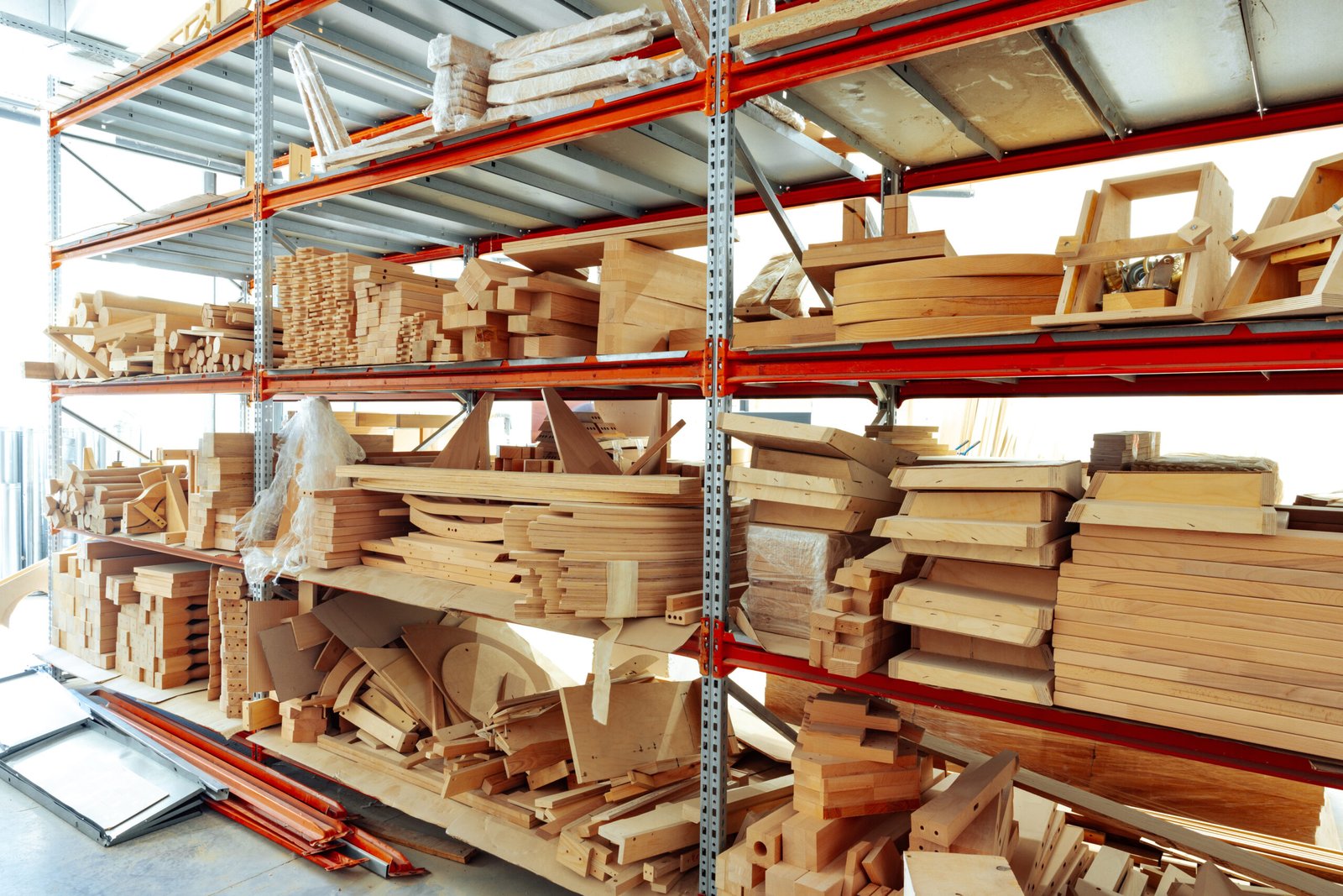 Stacked wooden bars in workshop of furniture manufacture close up