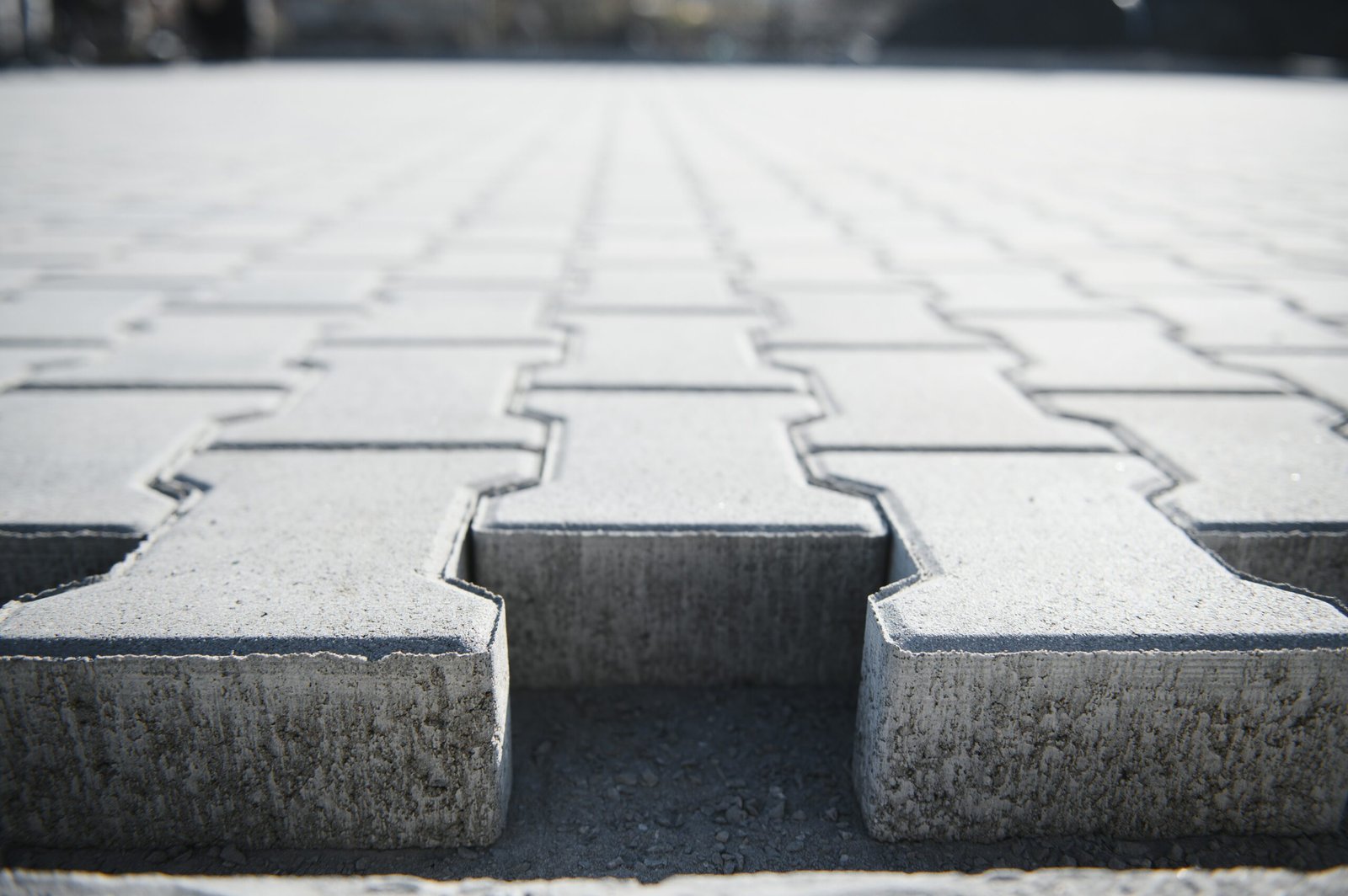 Stone pavement in perspective. Stone pavement texture. Granite cobblestoned pavement background. Abstract background of a cobblestone pavement.